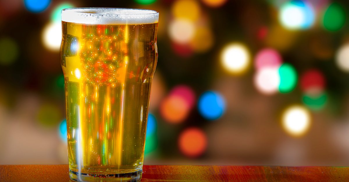 Beer on a bar with background holiday lights shining through it.