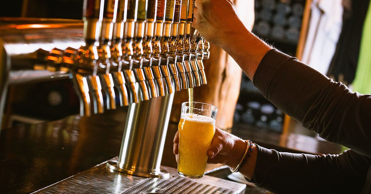 golden ipa being poured in taproom x