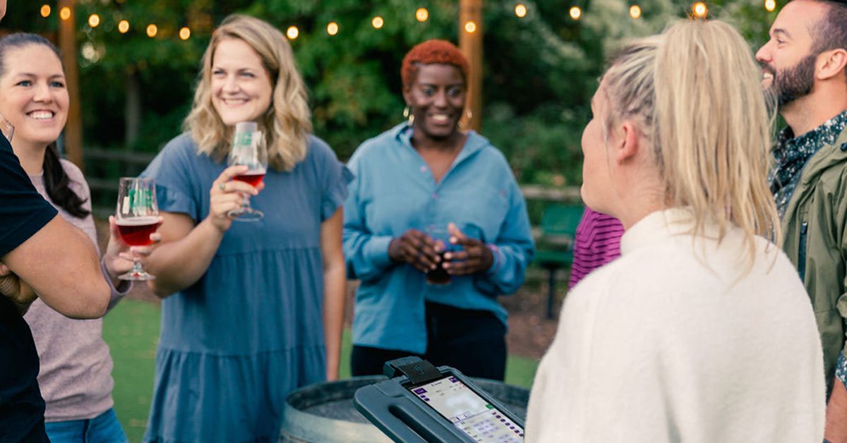 group of young people enjoying beer outdoors