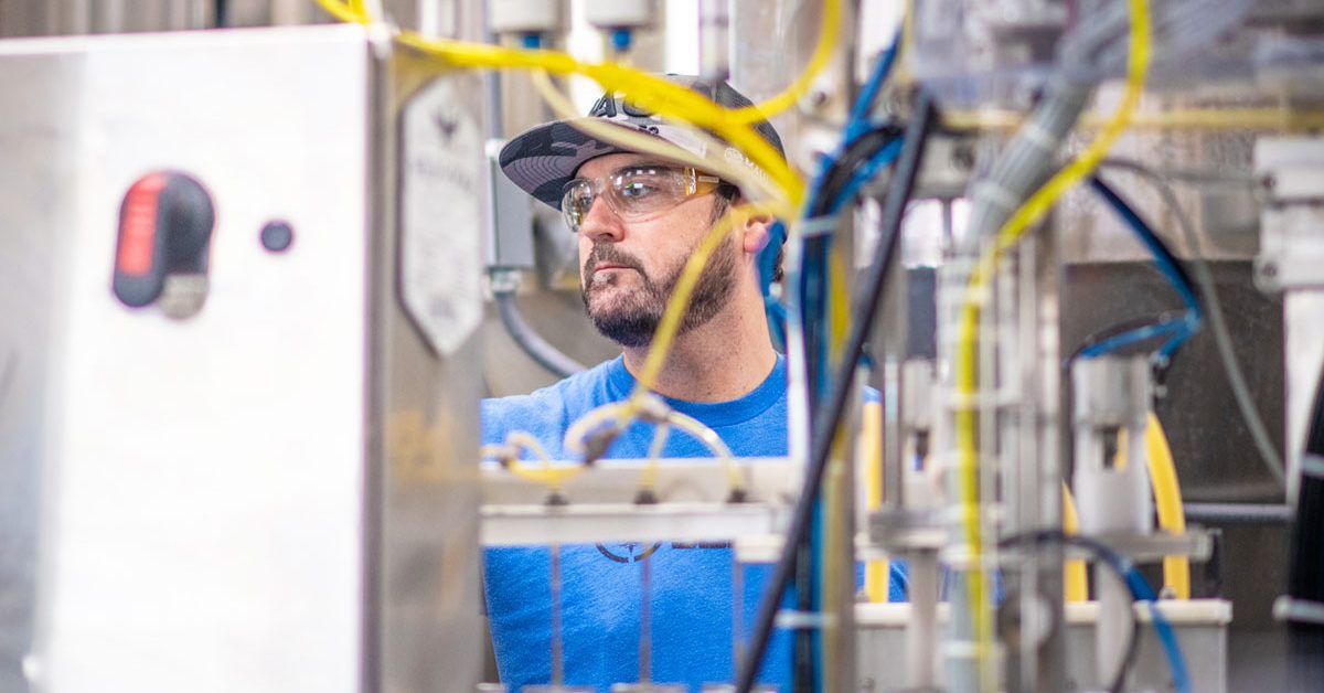 man working on canning line