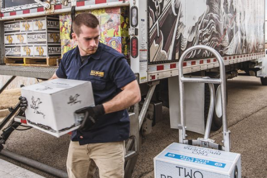 man unloads craft beer from truck